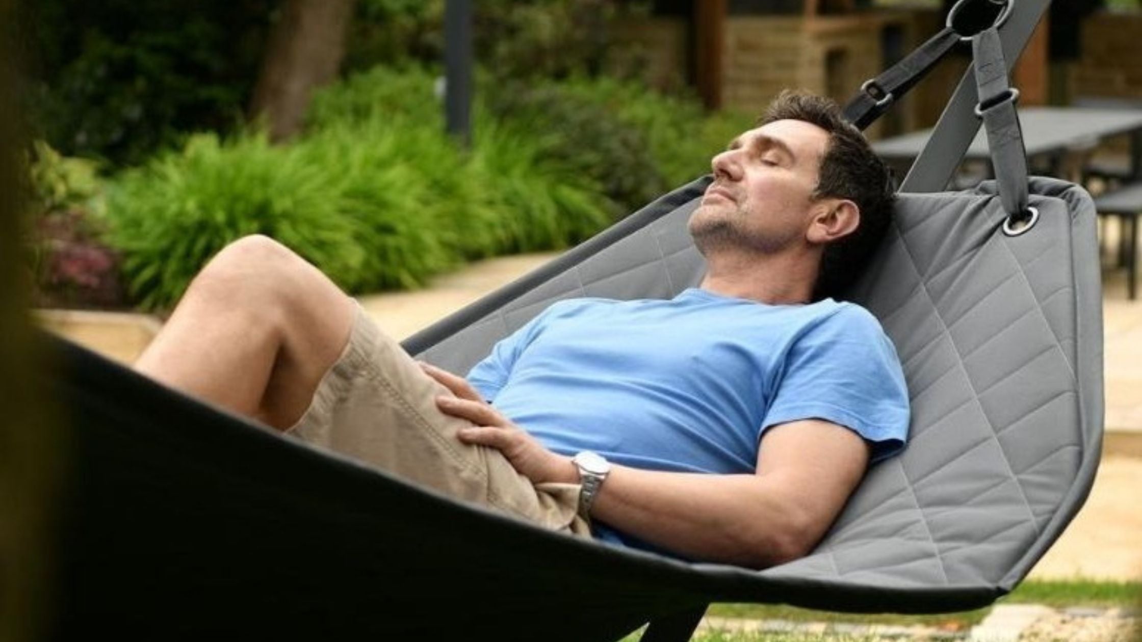A man relaxing on a hammock.