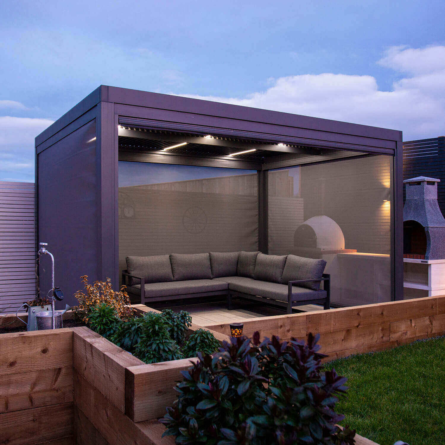 Textilene pull down privacy screens attached to a grey aluminium pergola.