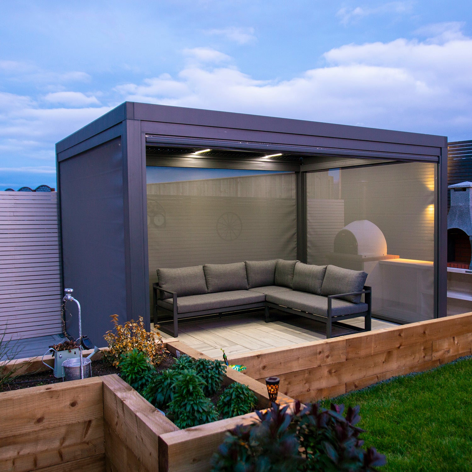 Textilene pull down privacy screens attached to a grey aluminium pergola.