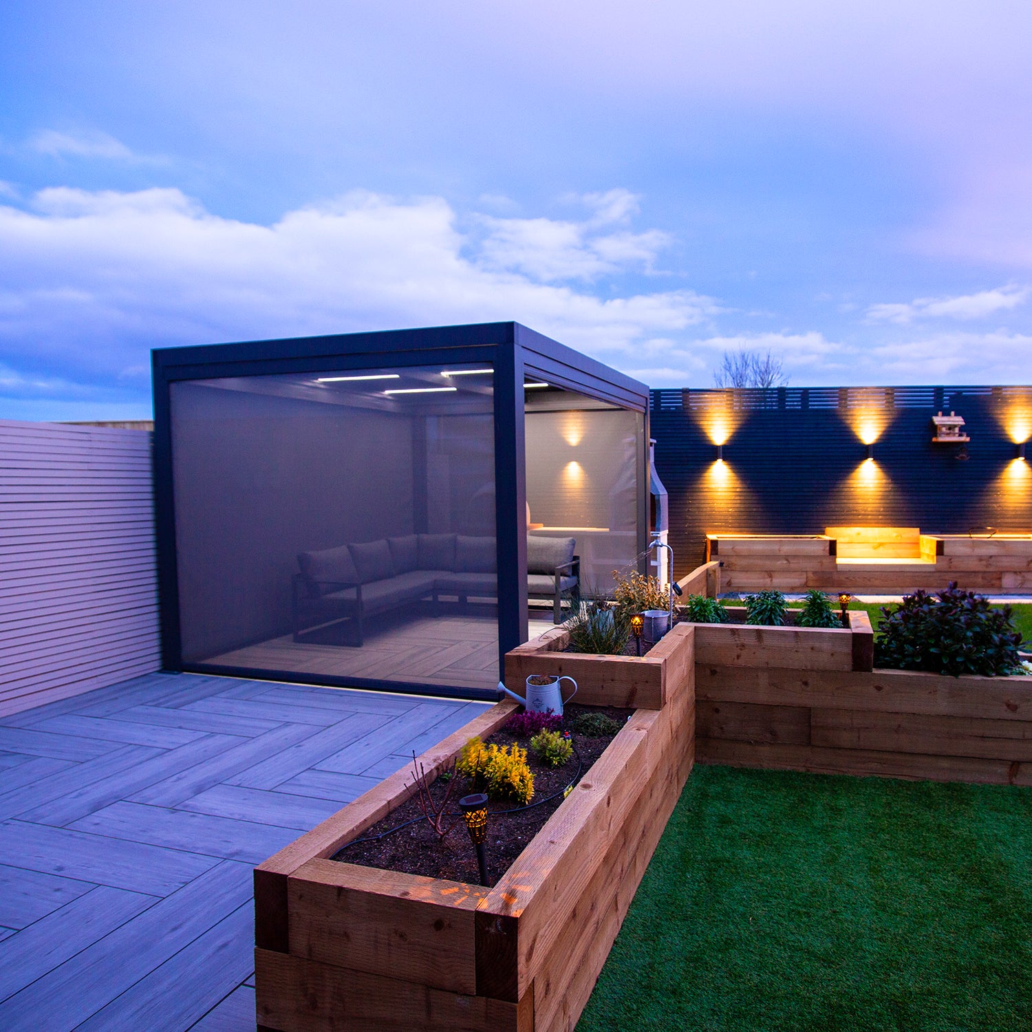 Textilene pull down privacy screens attached to a grey aluminium pergola.