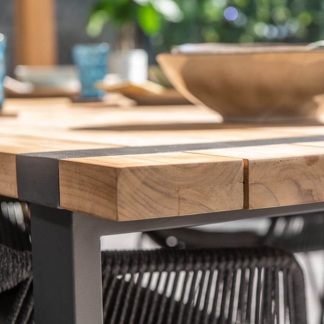 Close up of a corner of a teak table top.