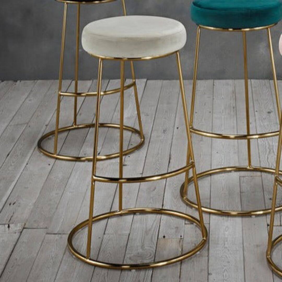 Velvet bar stool with gold frame base.