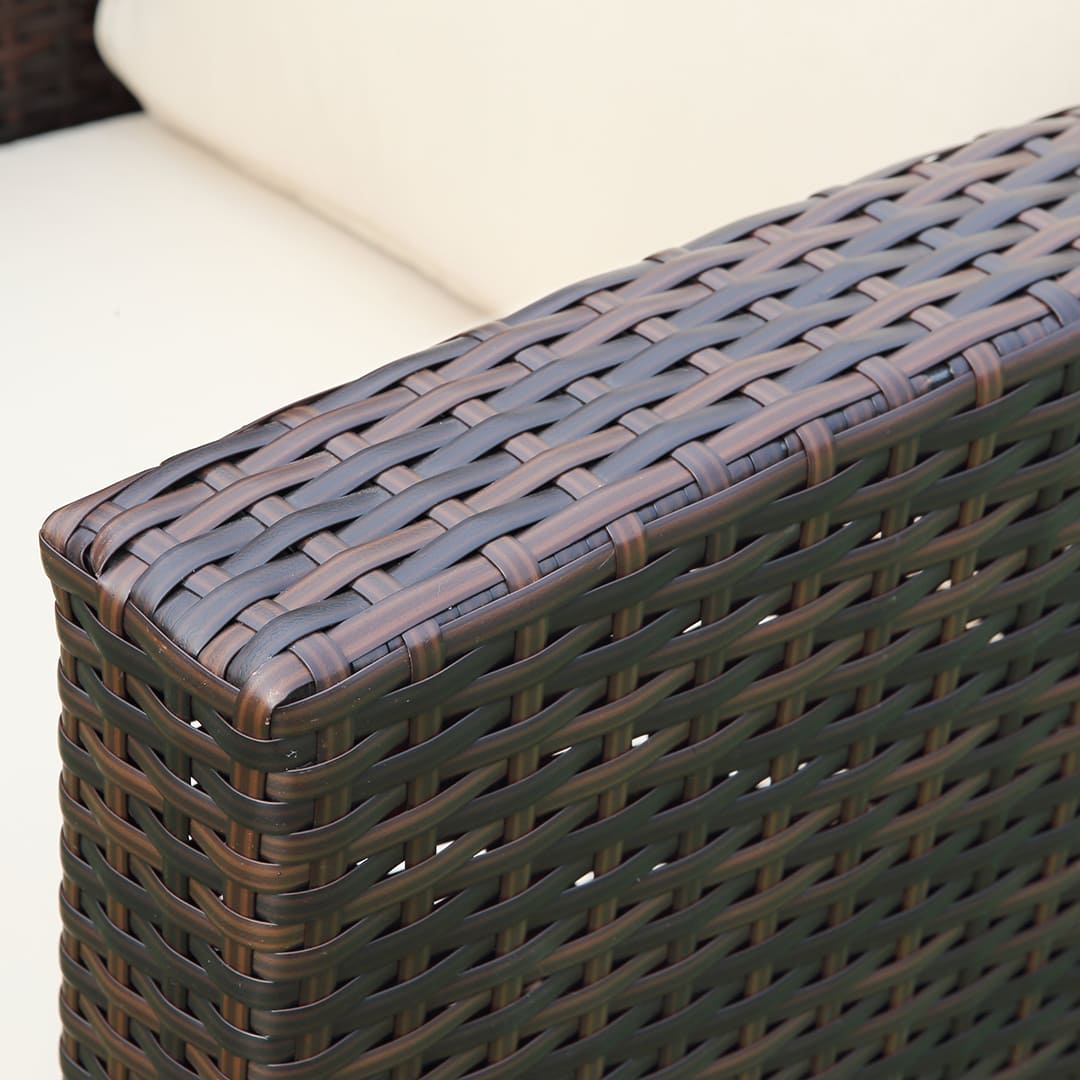 Close up of a brown rattan chair arm #colour_brown