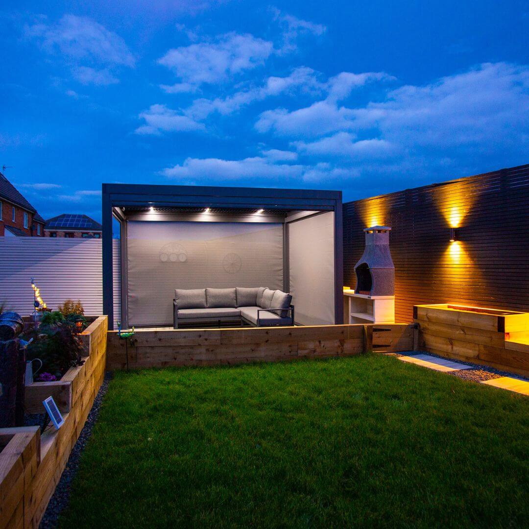 Textilene pull down privacy screens attached to a grey aluminium pergola.