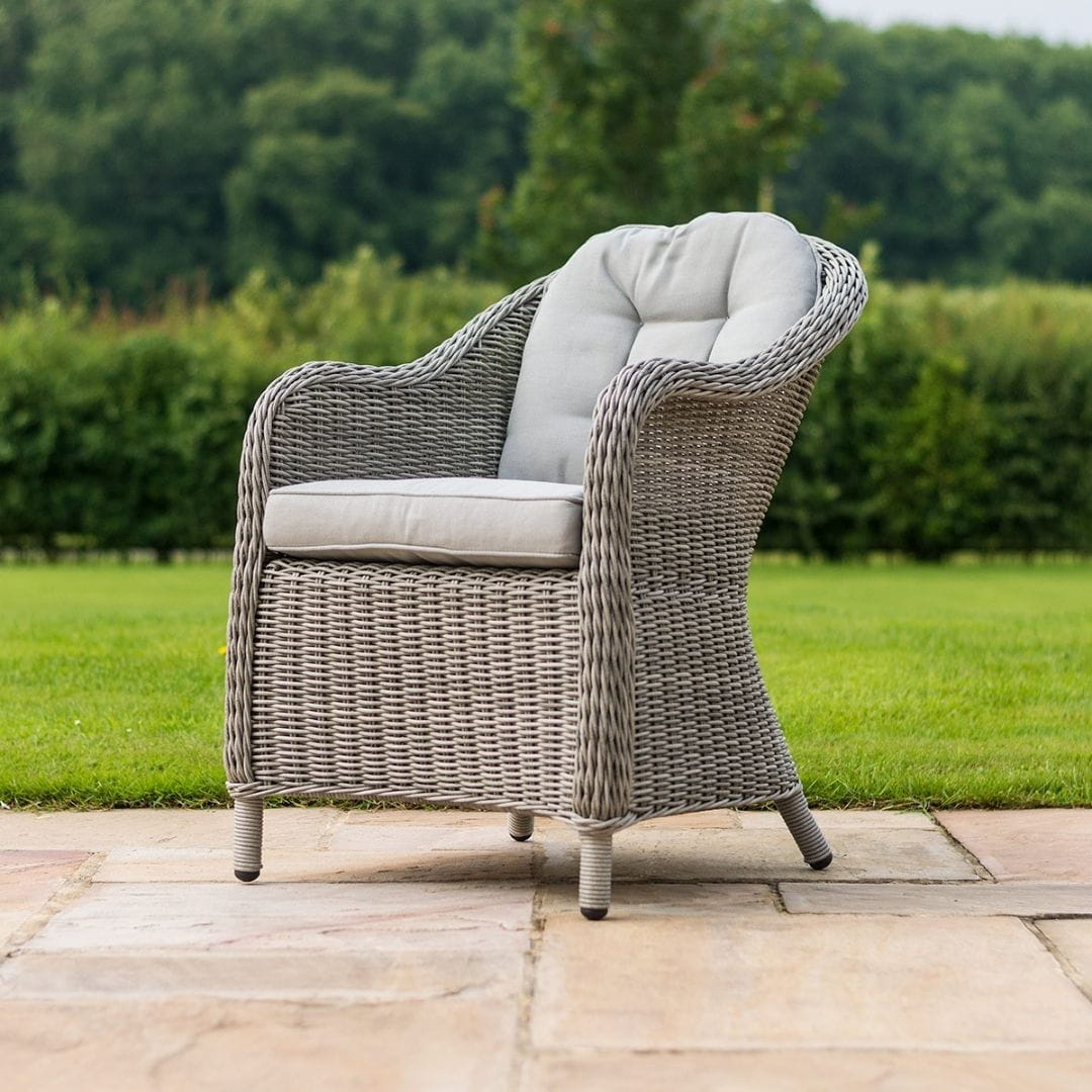 Close up of a light grey rattan dining chair