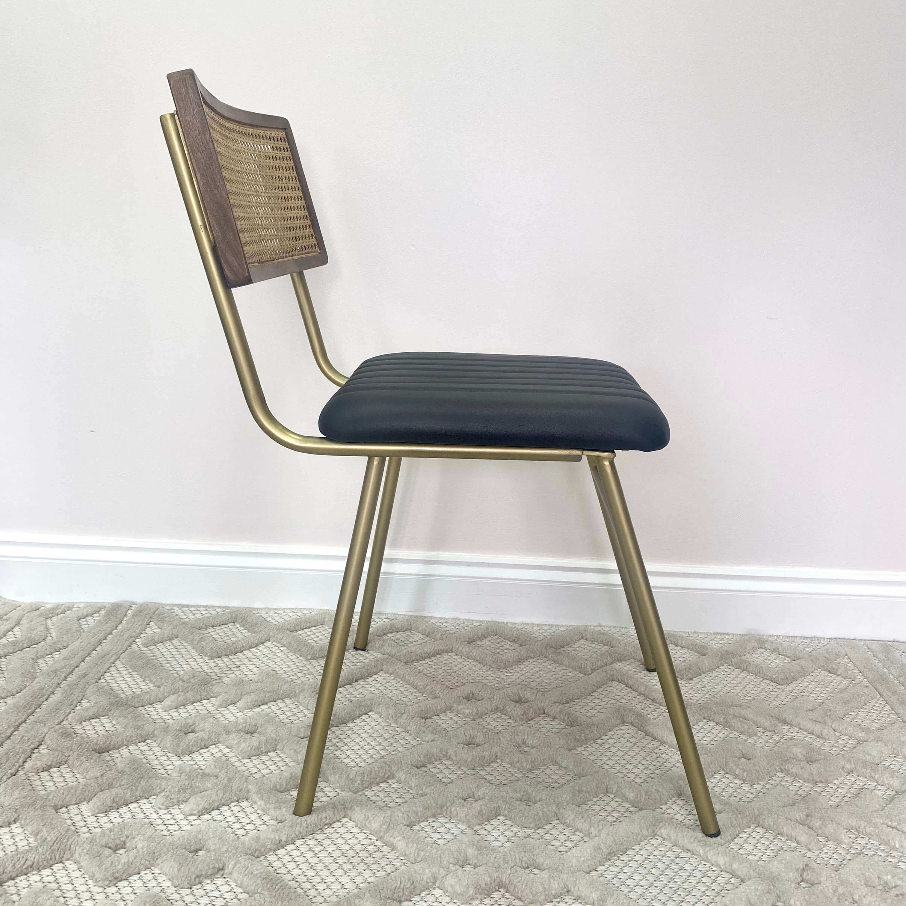 Side view of a rattan back dining chair.