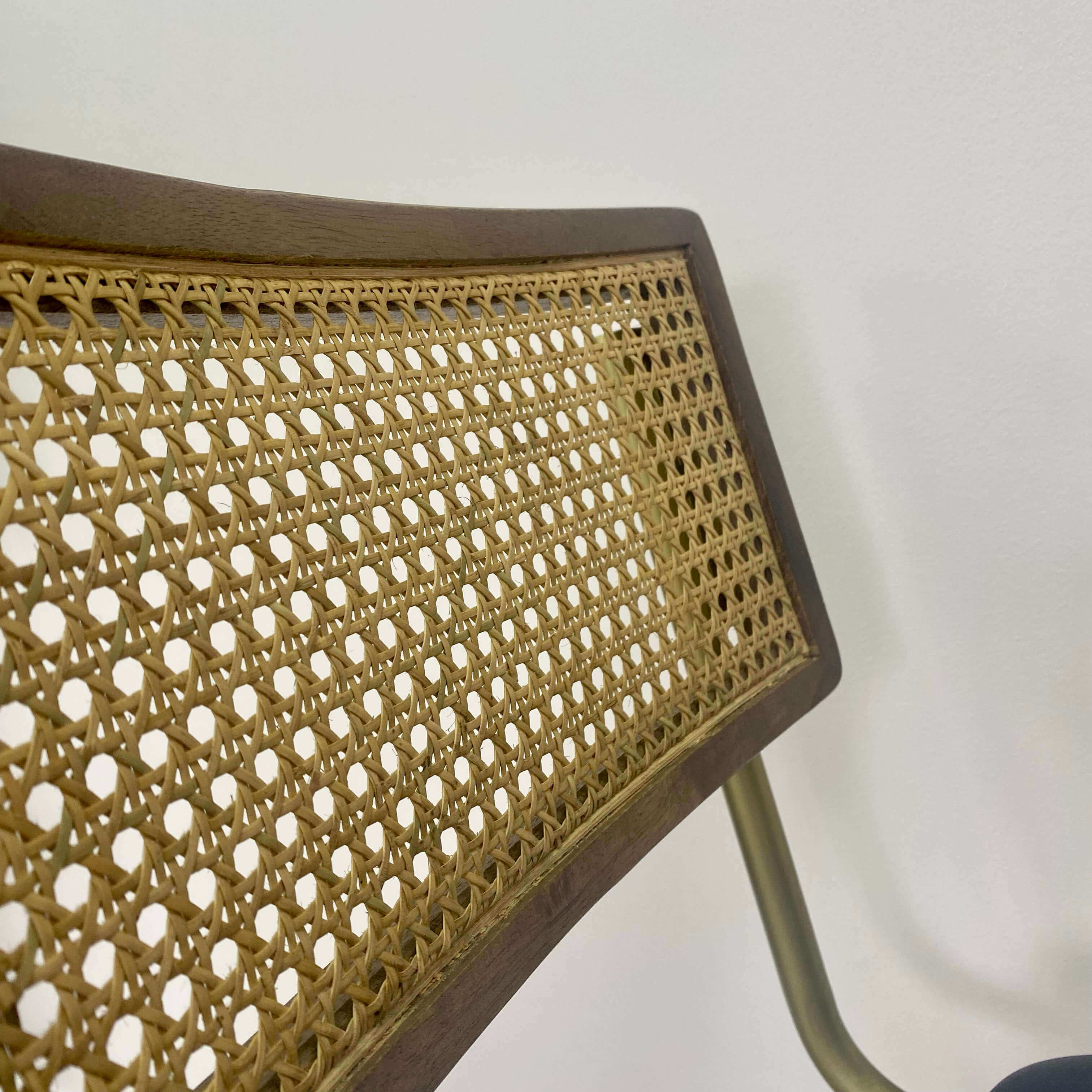 Close up of a rattan back of a dining chair.