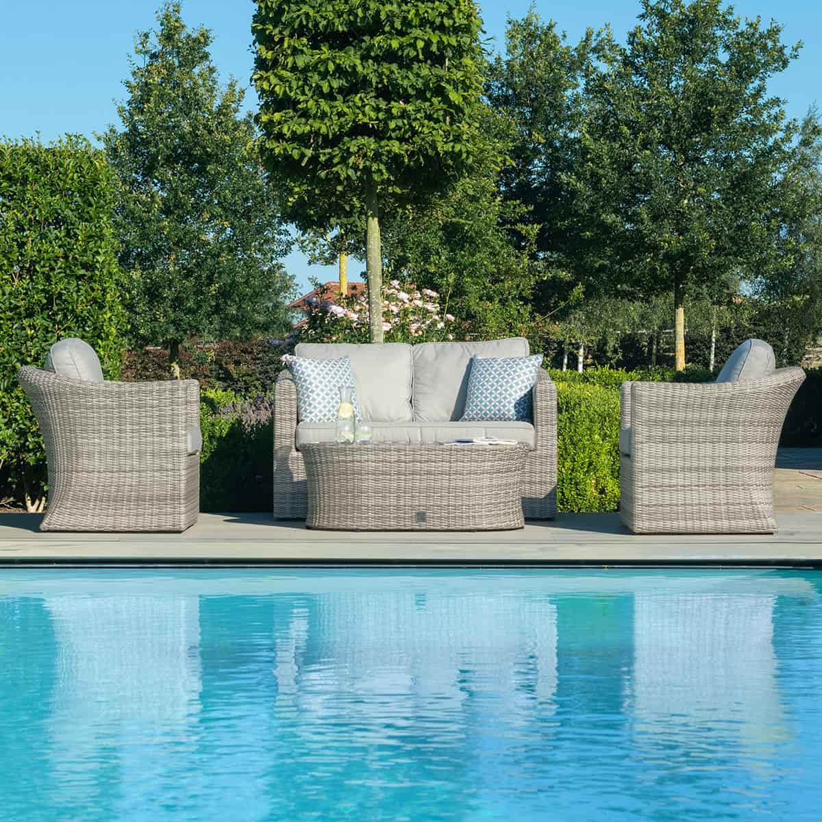 Light grey rattan 2 seat sofa set with two armchairs and a matching oval coffee table