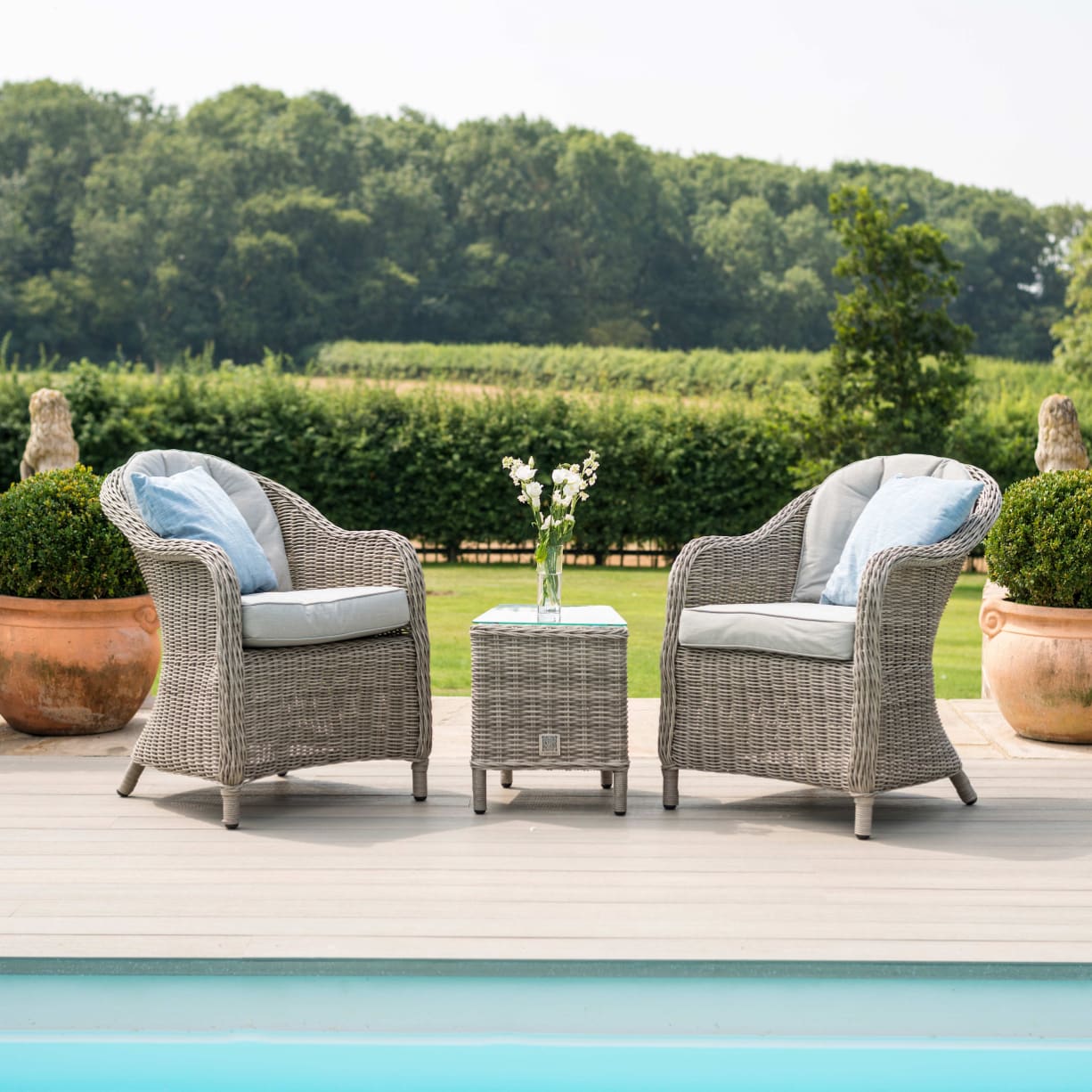 Light grey rattan lounge set with two armchairs and small table