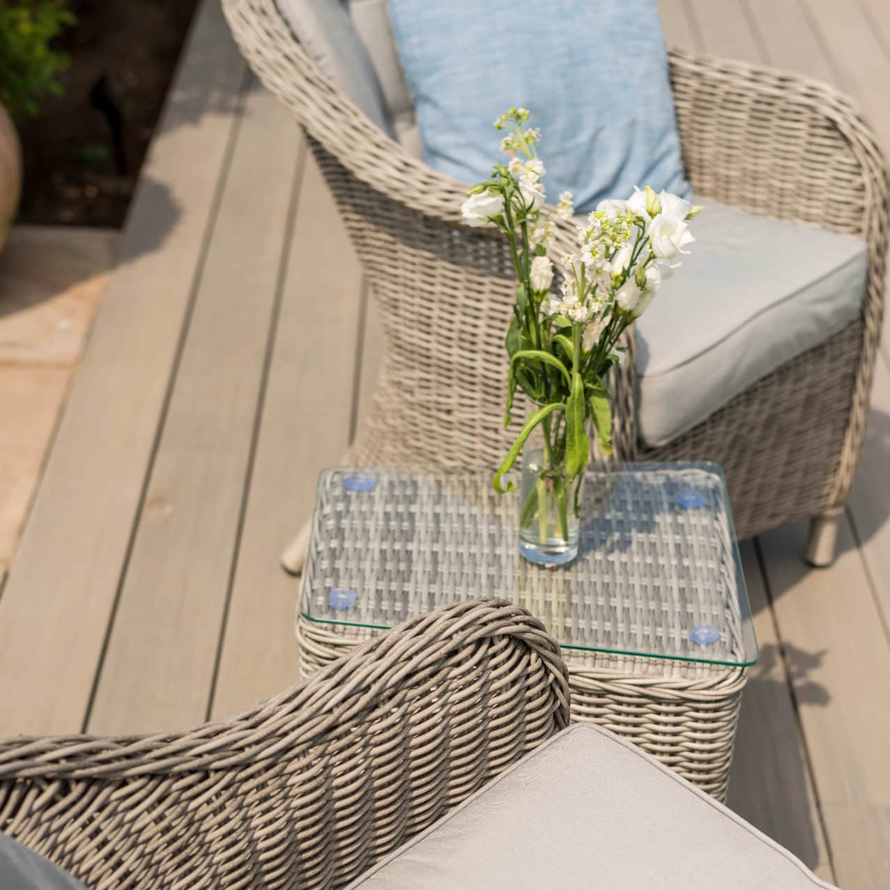 Light grey rattan lounge set with two armchairs and small table
