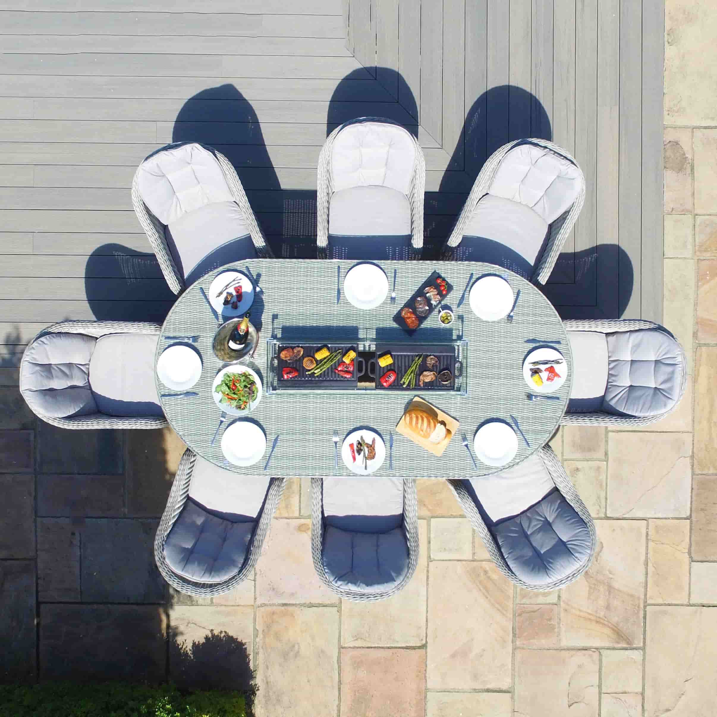 Overhead view of a light grey rattan 8 seat oval fire pit dining set with heritage chairs