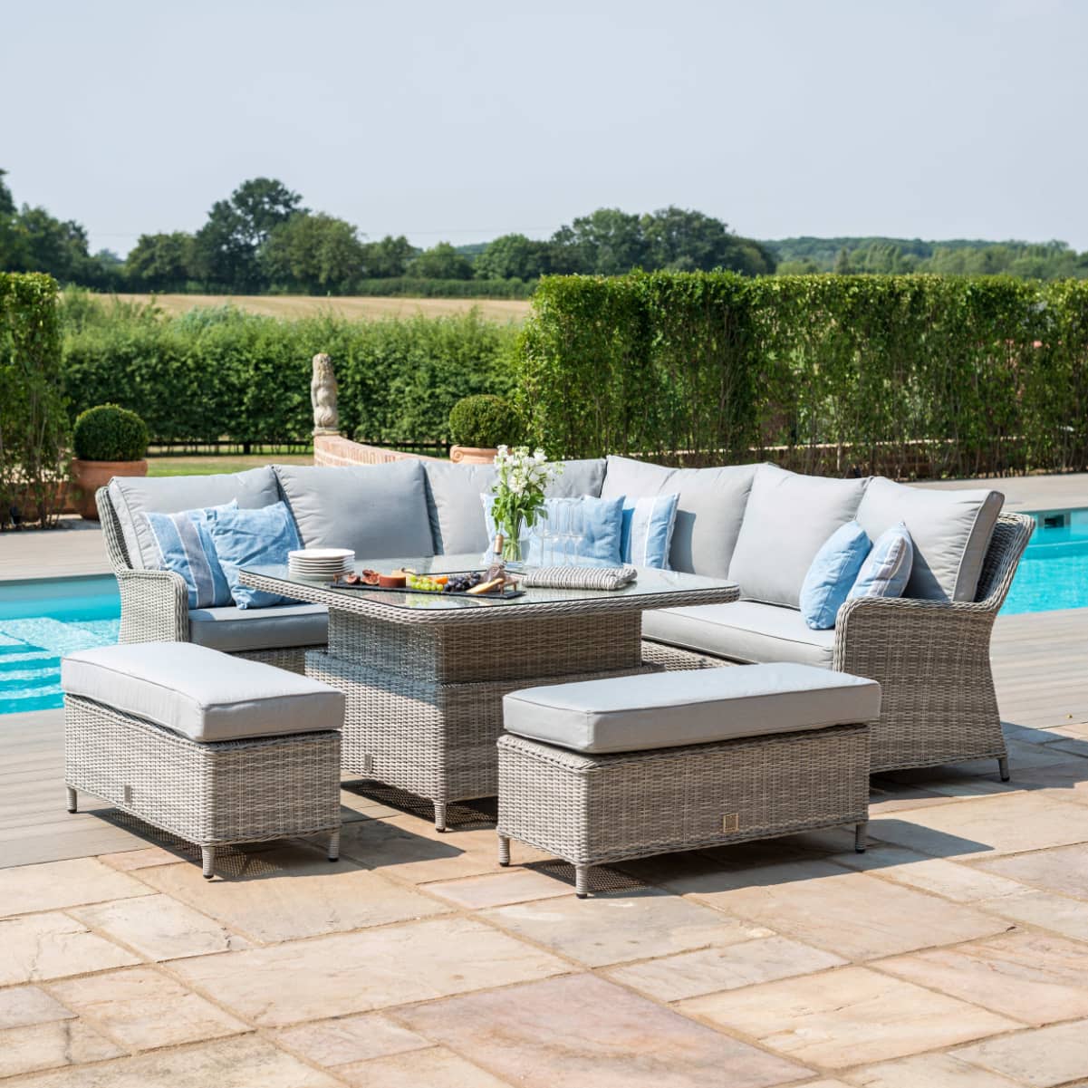 Light grey rattan corner sofa dining set with a square ice bucket rising table and two benches