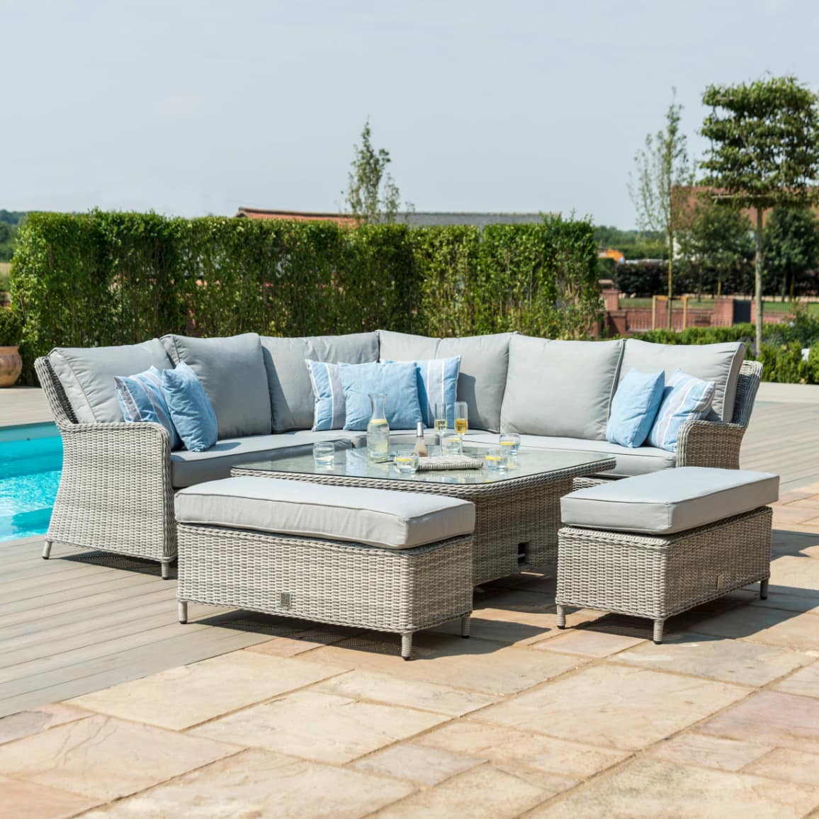 Light grey rattan corner sofa dining set with a square ice bucket rising table and two benches