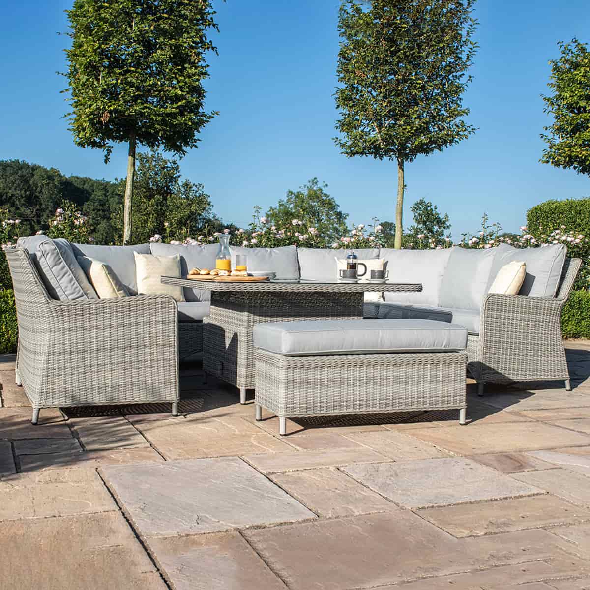 Light grey coloured rattan u shape sofa with matching bench and square rising table.