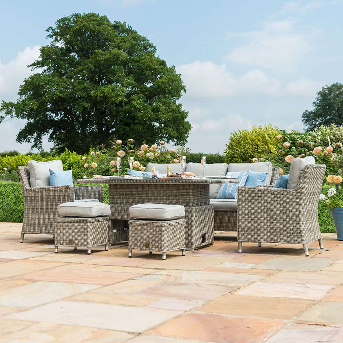 Light grey rattan sofa dining set with rectangular ice bucket rising table, two armchairs and two stools