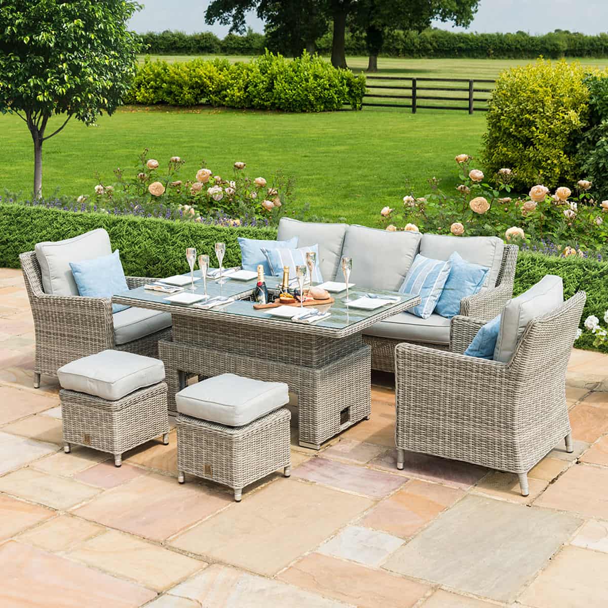 Light grey rattan sofa dining set with rectangular ice bucket rising table, two armchairs and two stools