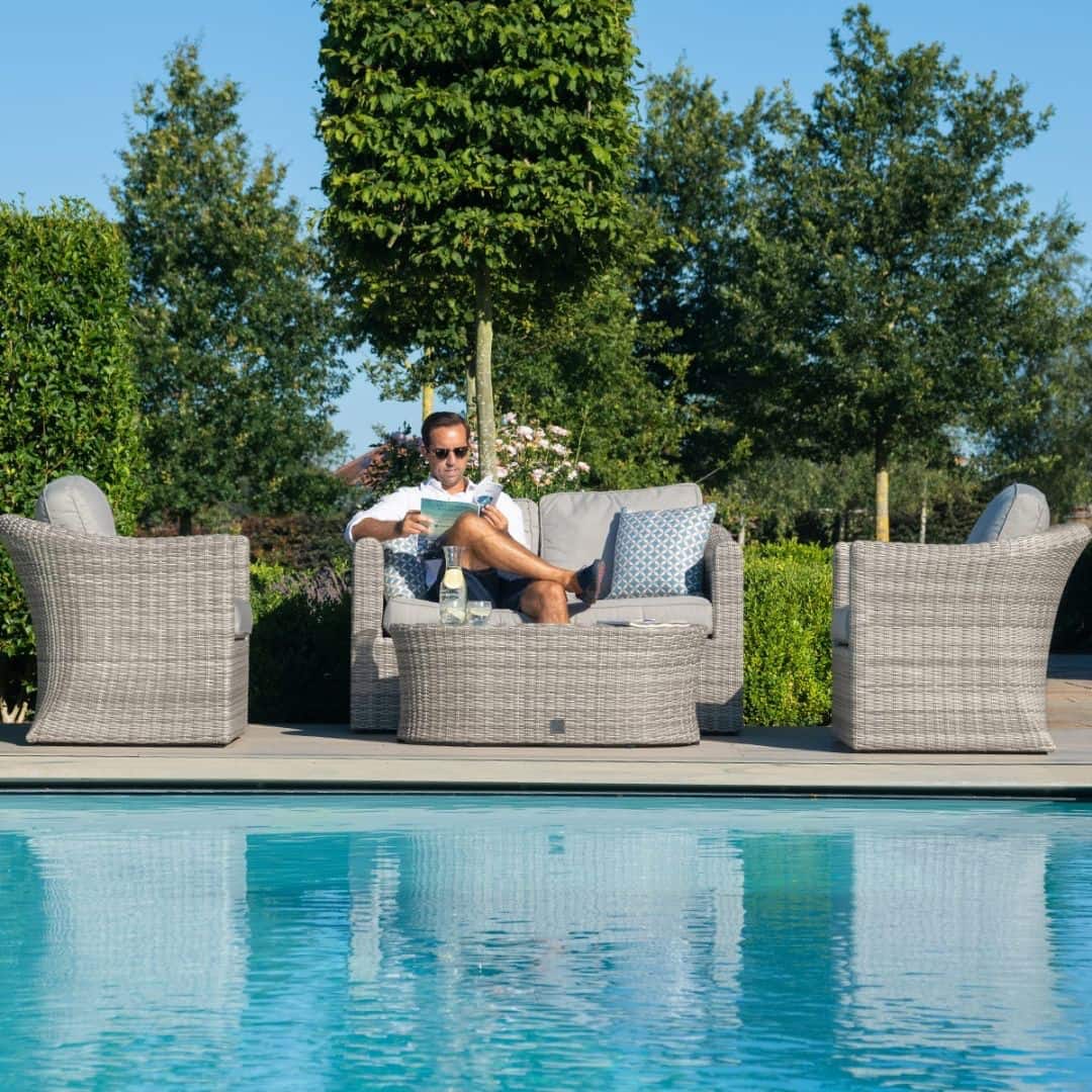 Light grey rattan 2 seat sofa set with two armchairs and a matching oval coffee table