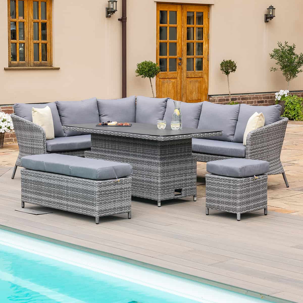 Grey rattan casual corner dining set with rectangular rising table, bench and a stool
