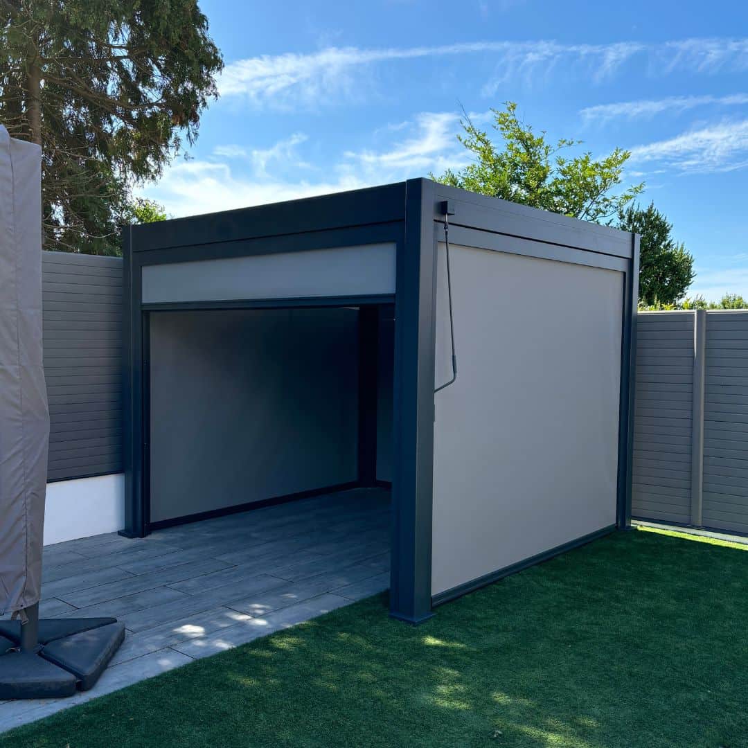 2.5m fibreglass textilene pull down privacy screen attached to a grey aluminium pergola
