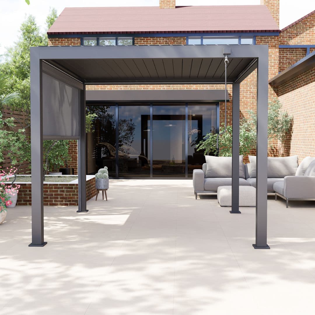 Front view of a grey aluminium pergola with louvred roof. The white LED lights underneath the roof panel are turned off.