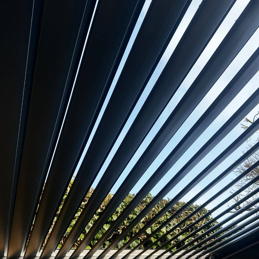 Underneath roof view of a grey aluminium pergola.