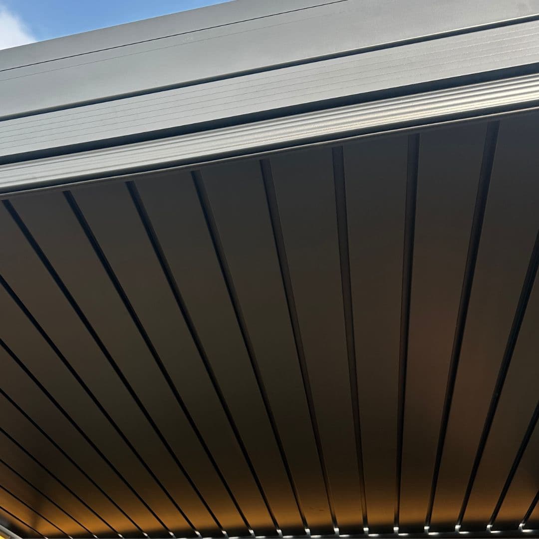 Underneath roof view of a grey aluminium pergola.