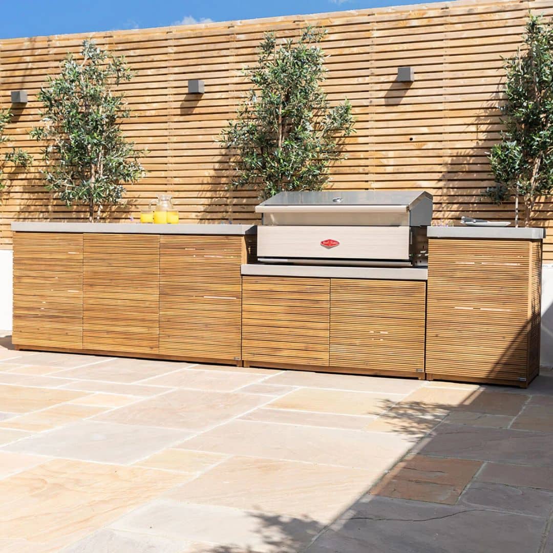 Acacia wood and a composite concrete worktop outdoor kitchen unit with bbq grill.