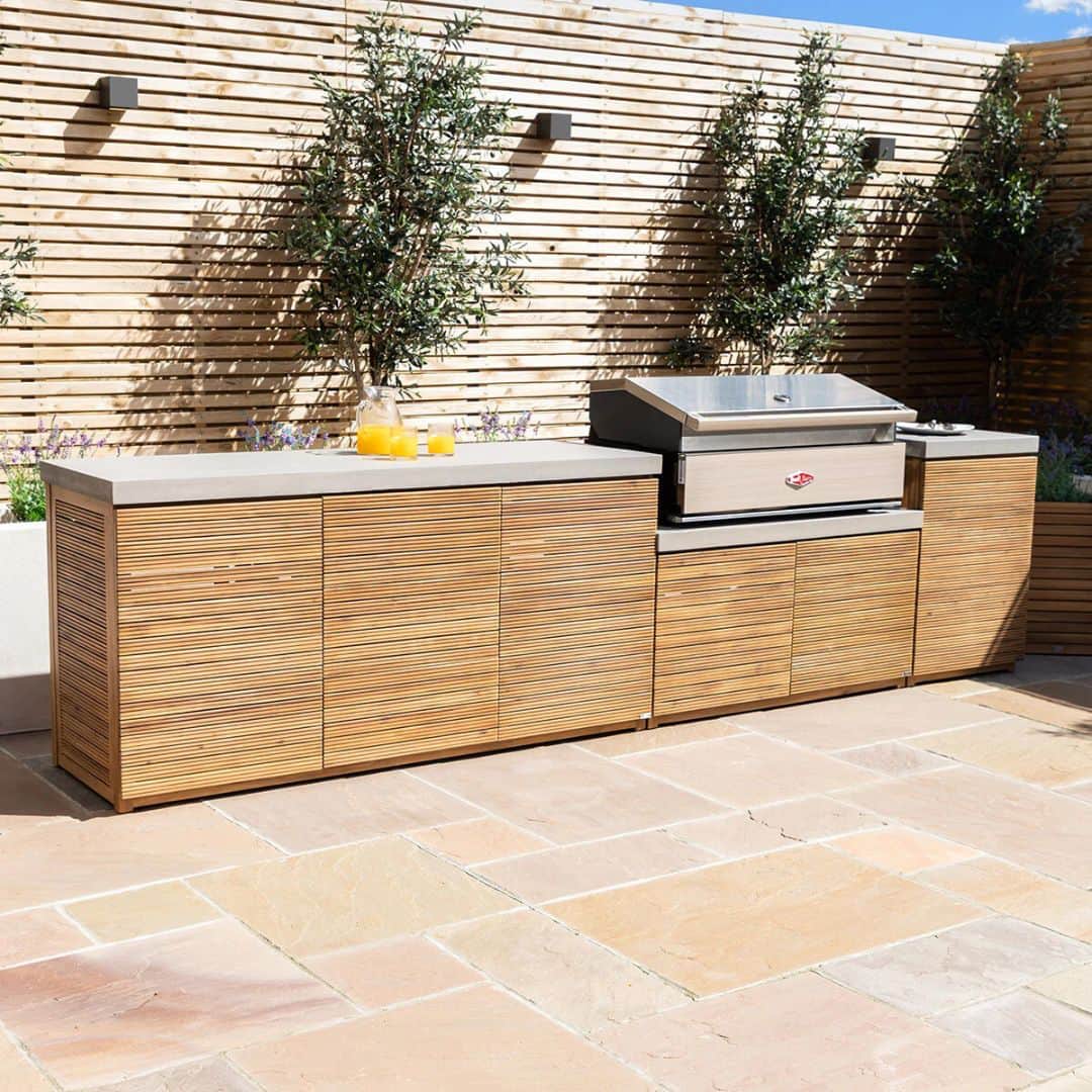 Acacia wood and a composite concrete worktop outdoor kitchen unit with bbq grill.