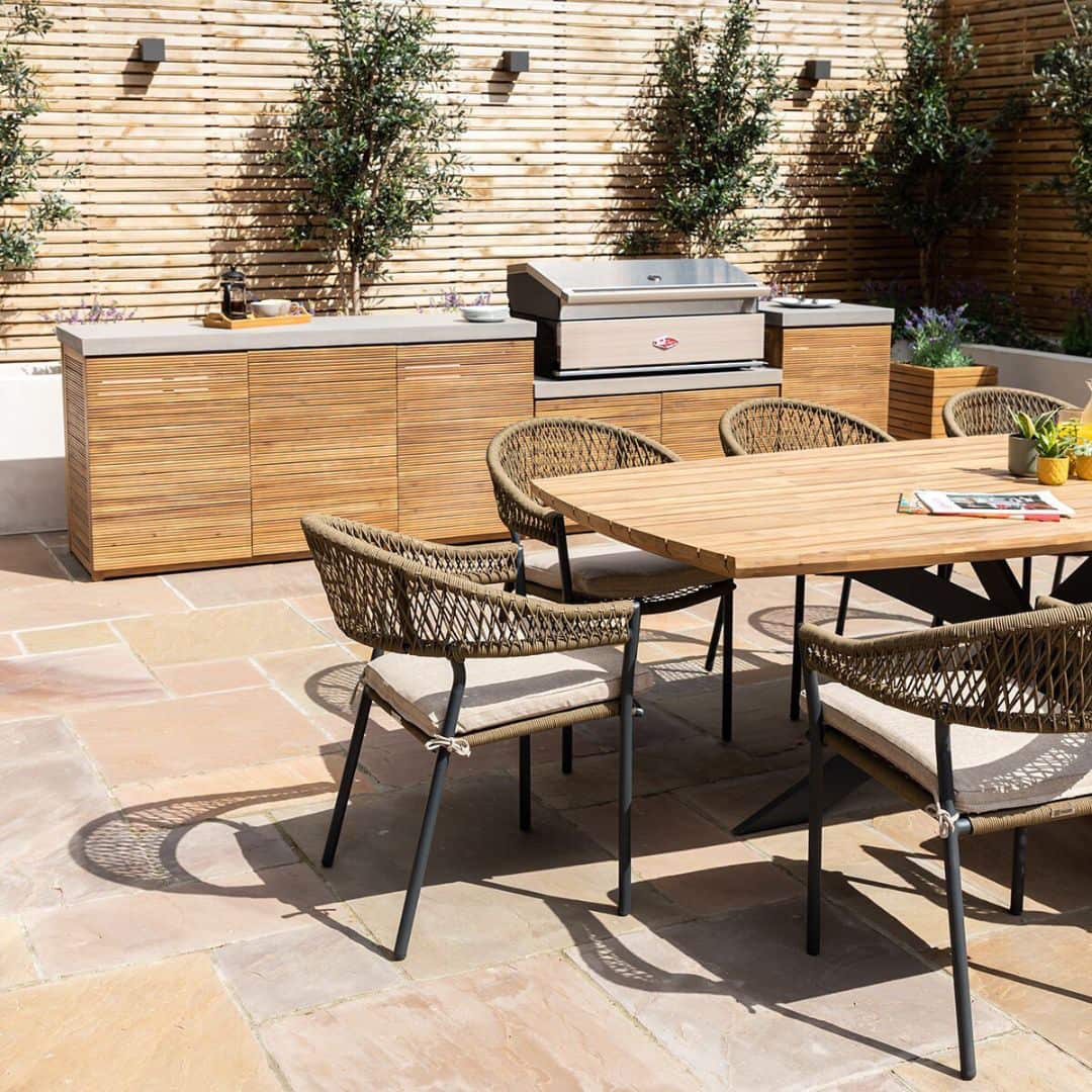 Acacia wood and a composite concrete worktop outdoor kitchen unit with bbq grill.