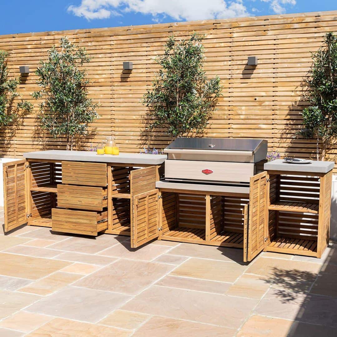 Acacia wood and a composite concrete worktop outdoor kitchen unit with bbq grill.