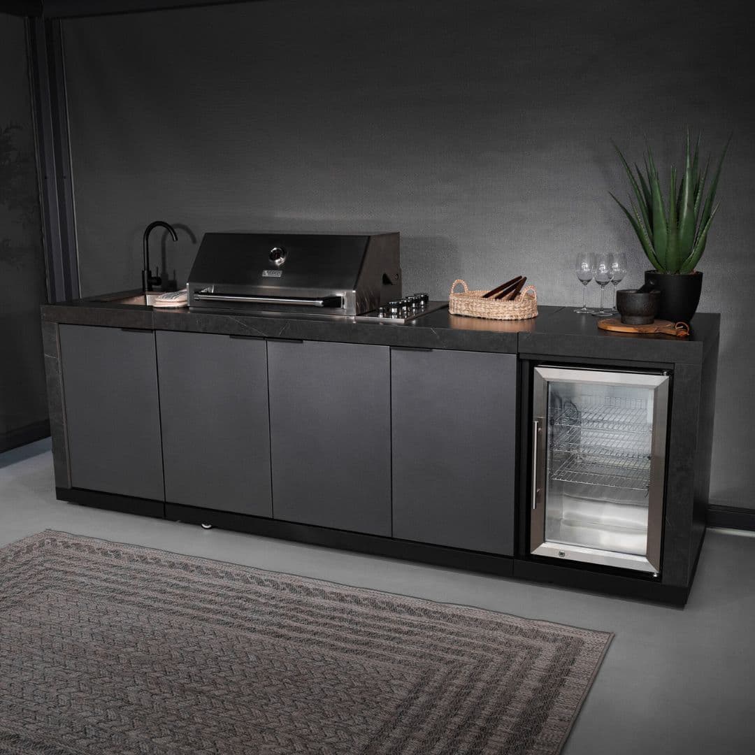 Grey outdoor kitchen unit with a bbq top unit, sink and fridge.