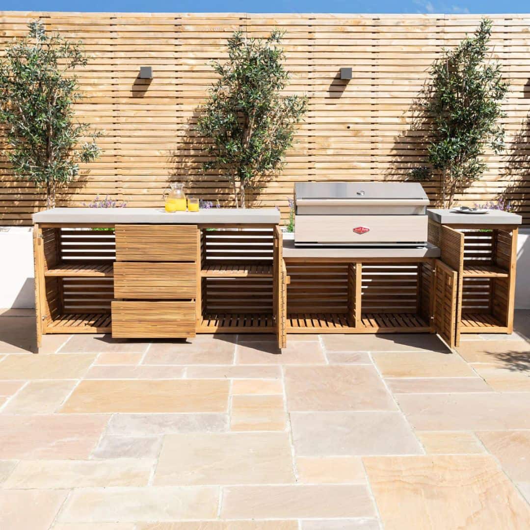 Acacia wood and a composite concrete worktop outdoor kitchen unit with bbq grill.