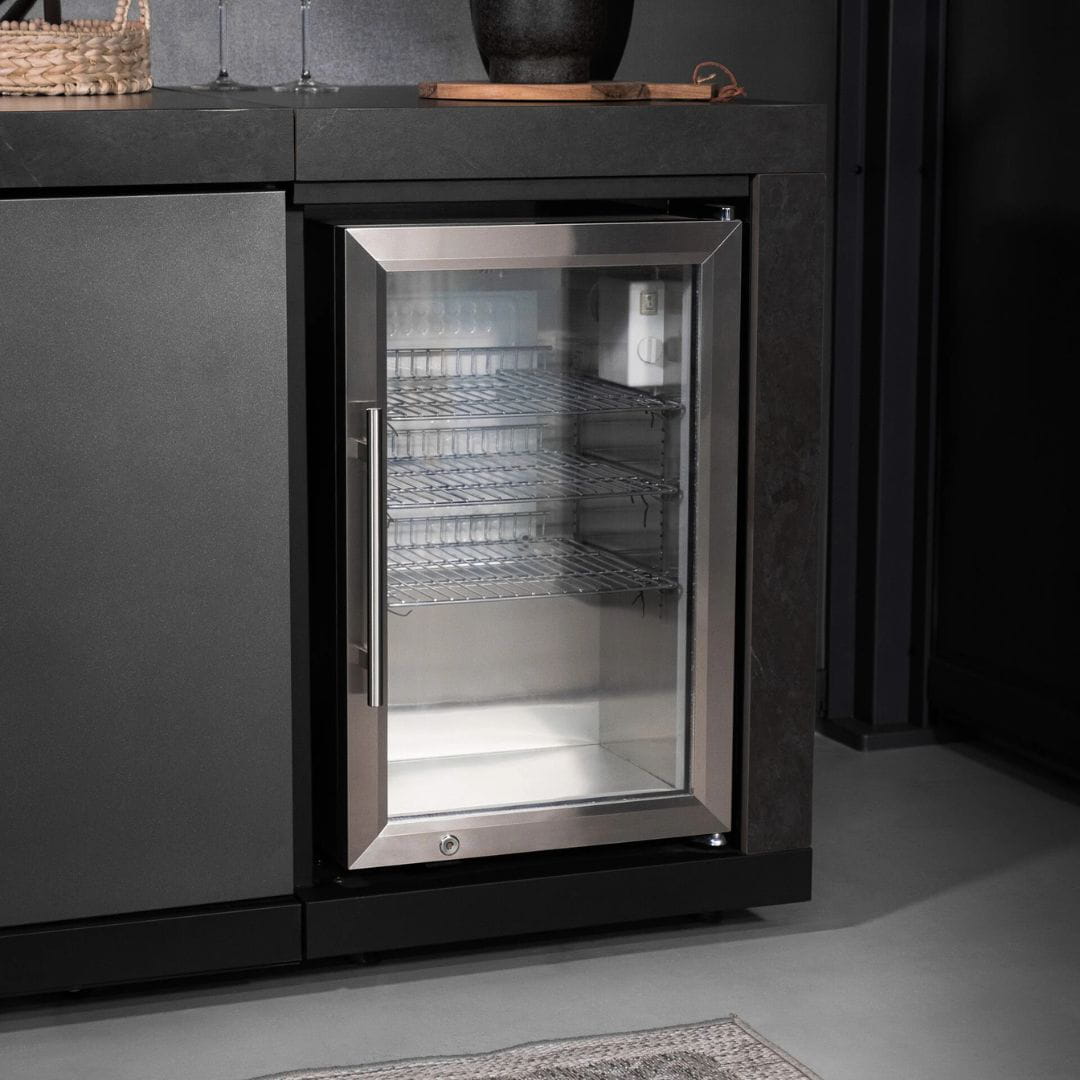 Grey outdoor kitchen unit with a bbq top unit, sink and fridge.