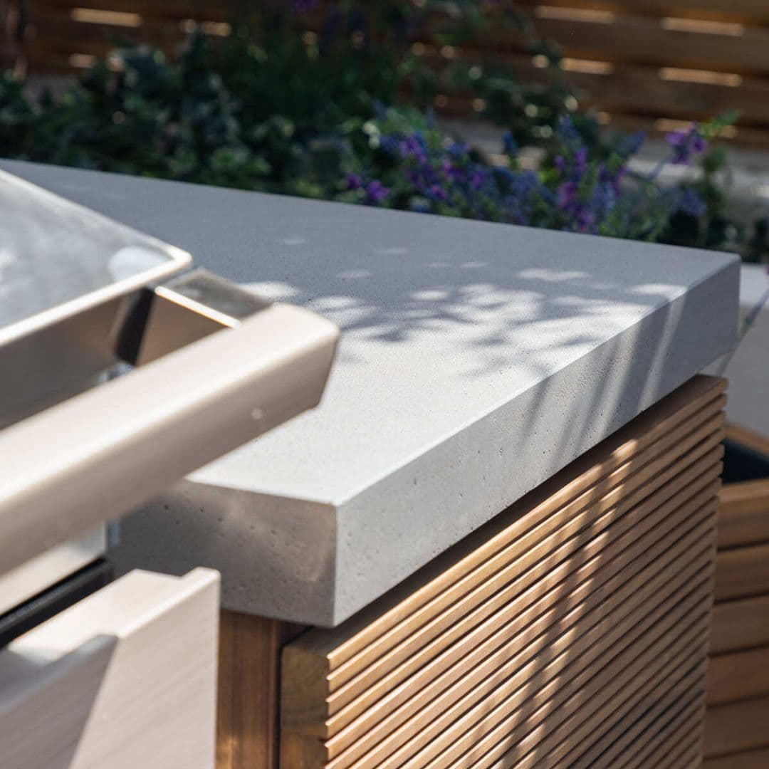 Acacia wood and a composite concrete worktop outdoor kitchen unit.