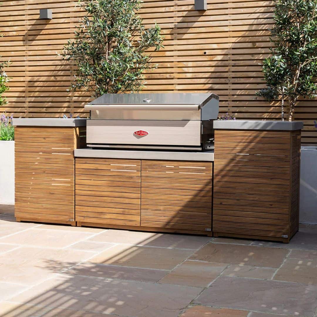 Acacia wood and a composite concrete worktop outdoor kitchen unit with bbq grill.