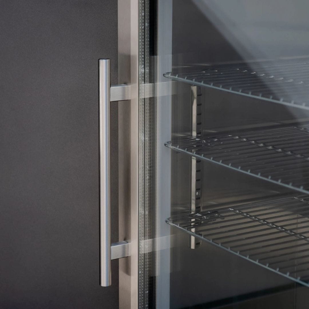 Grey outdoor kitchen unit with a bbq top unit, sink and fridge.