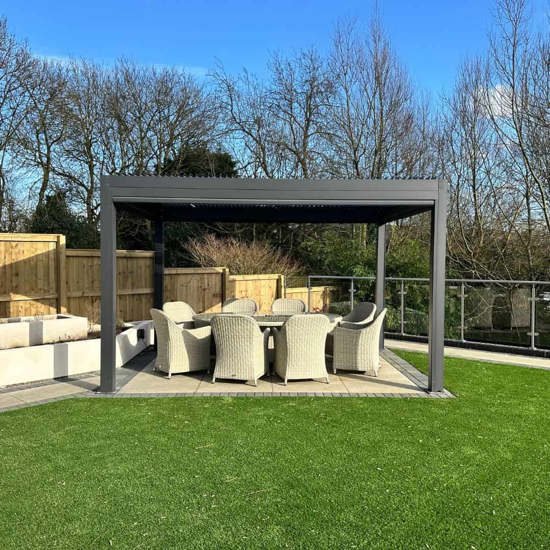 Anthracite grey aluminium pergola with 4 motorised zip screw and motorised louvred roof with LED lighting.