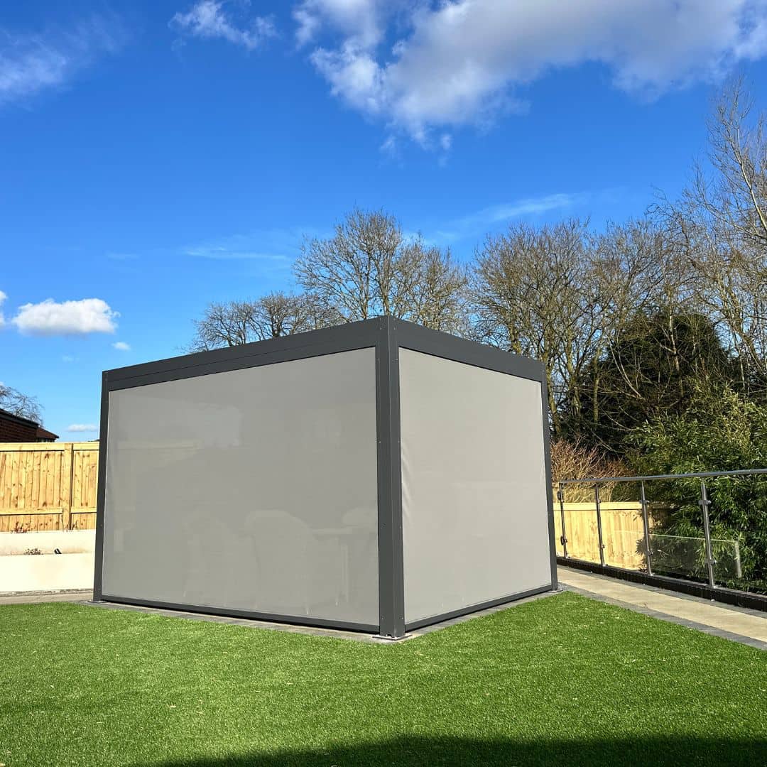 Anthracite grey aluminium pergola with 4 motorised zip screw and motorised louvred roof with LED lighting.