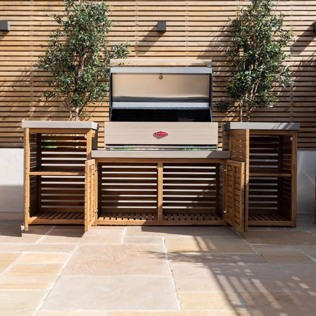 Acacia wood and a composite concrete worktop outdoor kitchen unit with bbq grill.