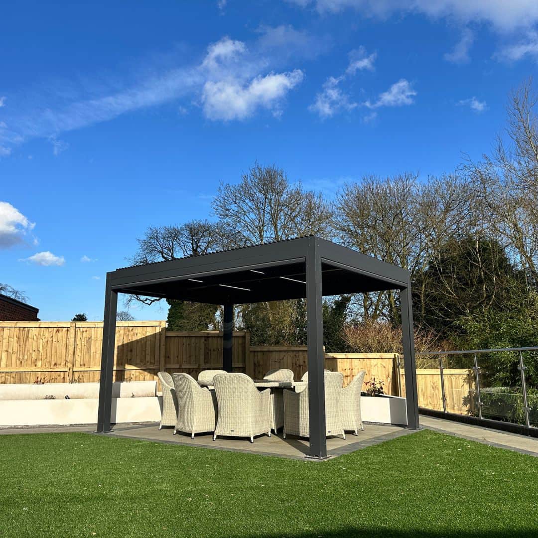 Anthracite grey aluminium pergola with 4 motorised zip screw and motorised louvred roof with LED lighting.