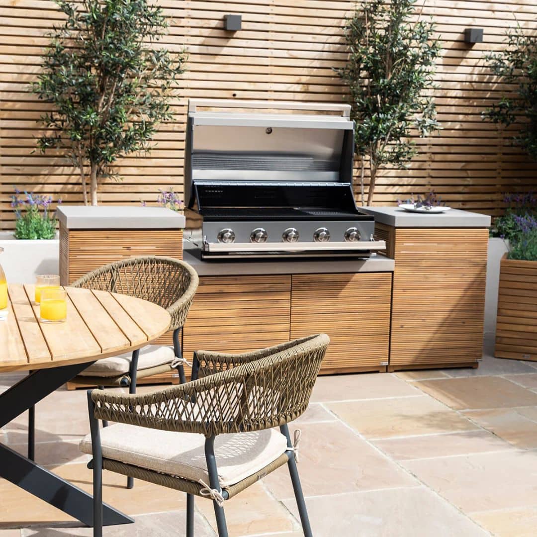 Acacia wood and a composite concrete worktop outdoor kitchen unit with bbq grill.