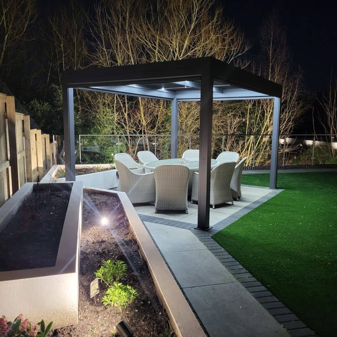 Anthracite grey aluminium pergola with 4 motorised zip screw and motorised louvred roof with LED lighting.