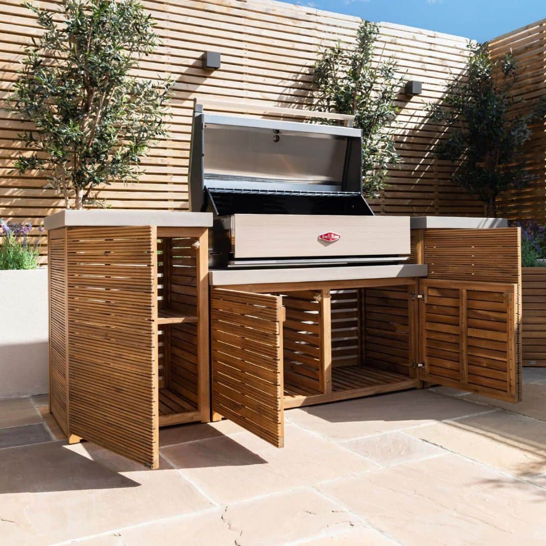 Acacia wood and a composite concrete worktop outdoor kitchen unit with bbq grill.