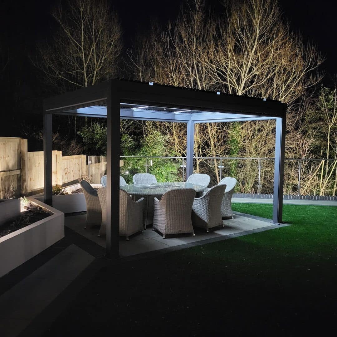 Anthracite grey aluminium pergola with 4 motorised zip screw and motorised louvred roof with LED lighting.