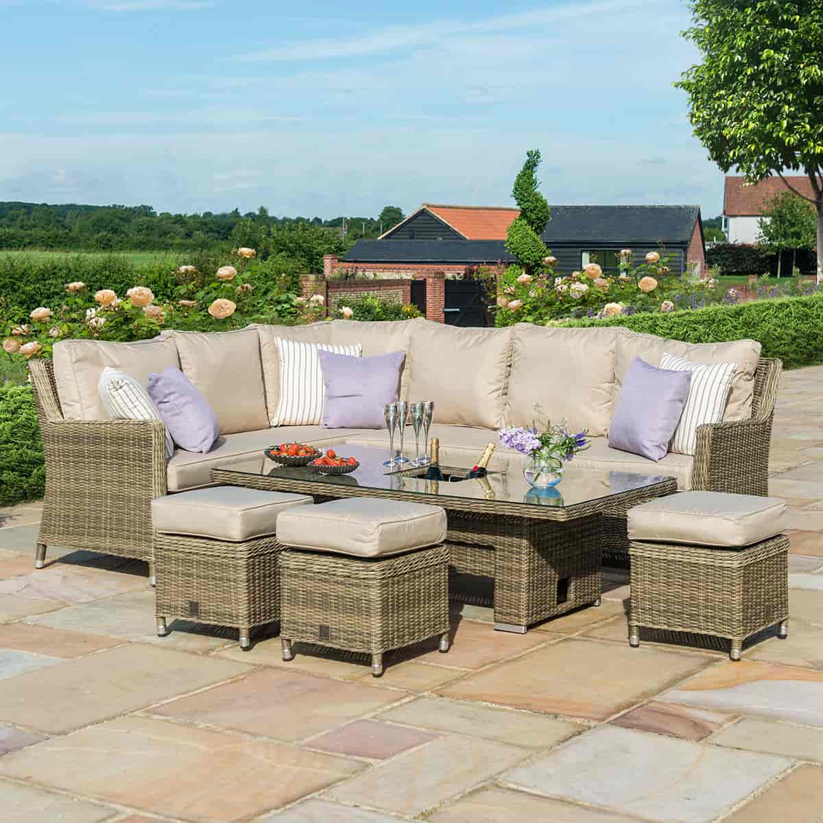 Natural coloured rattan corner dining set with three stools and rising table with ice bucket centrepiece