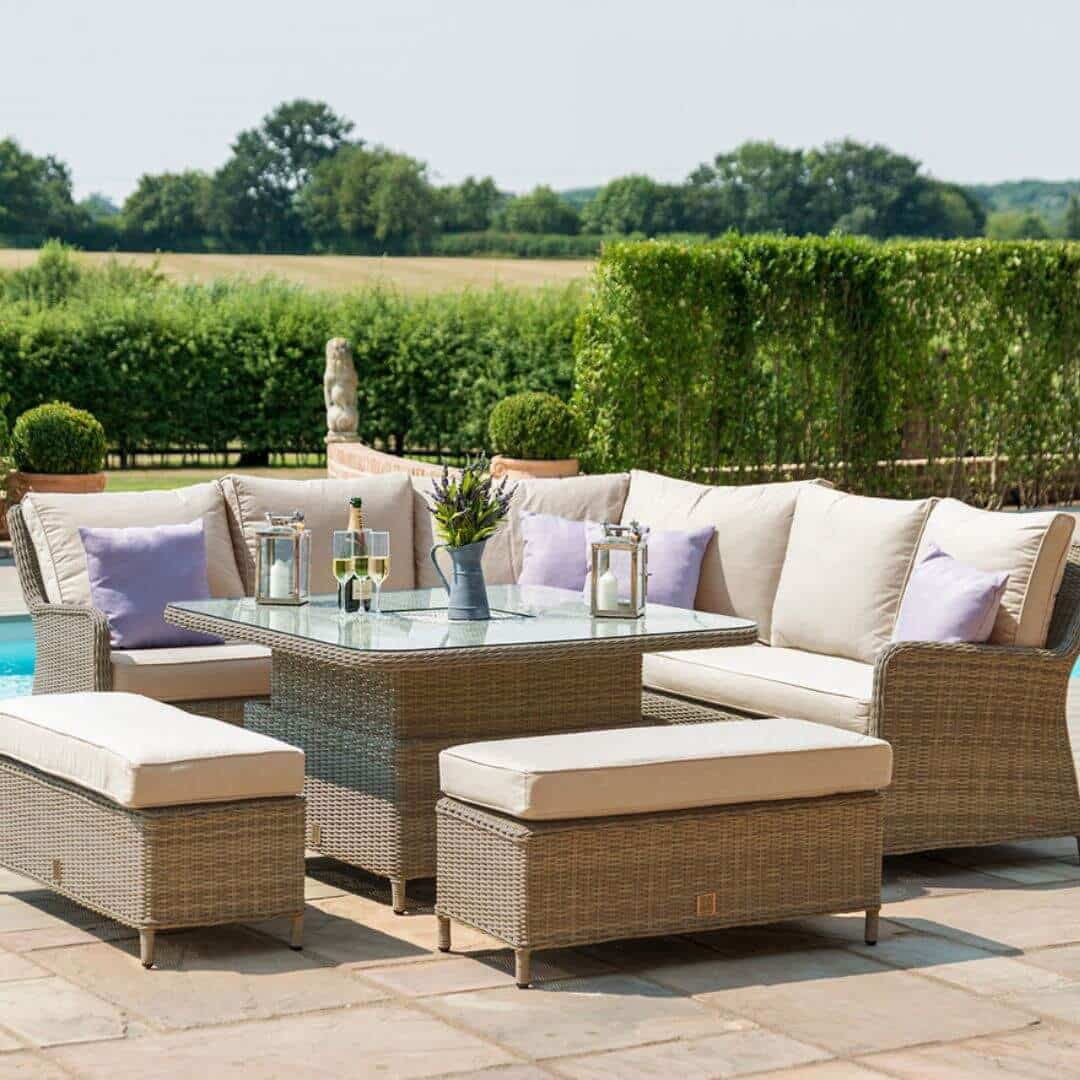 Natural coloured rattan corner sofa dining set with two benches and an ice bucket rising table. Table is risen.