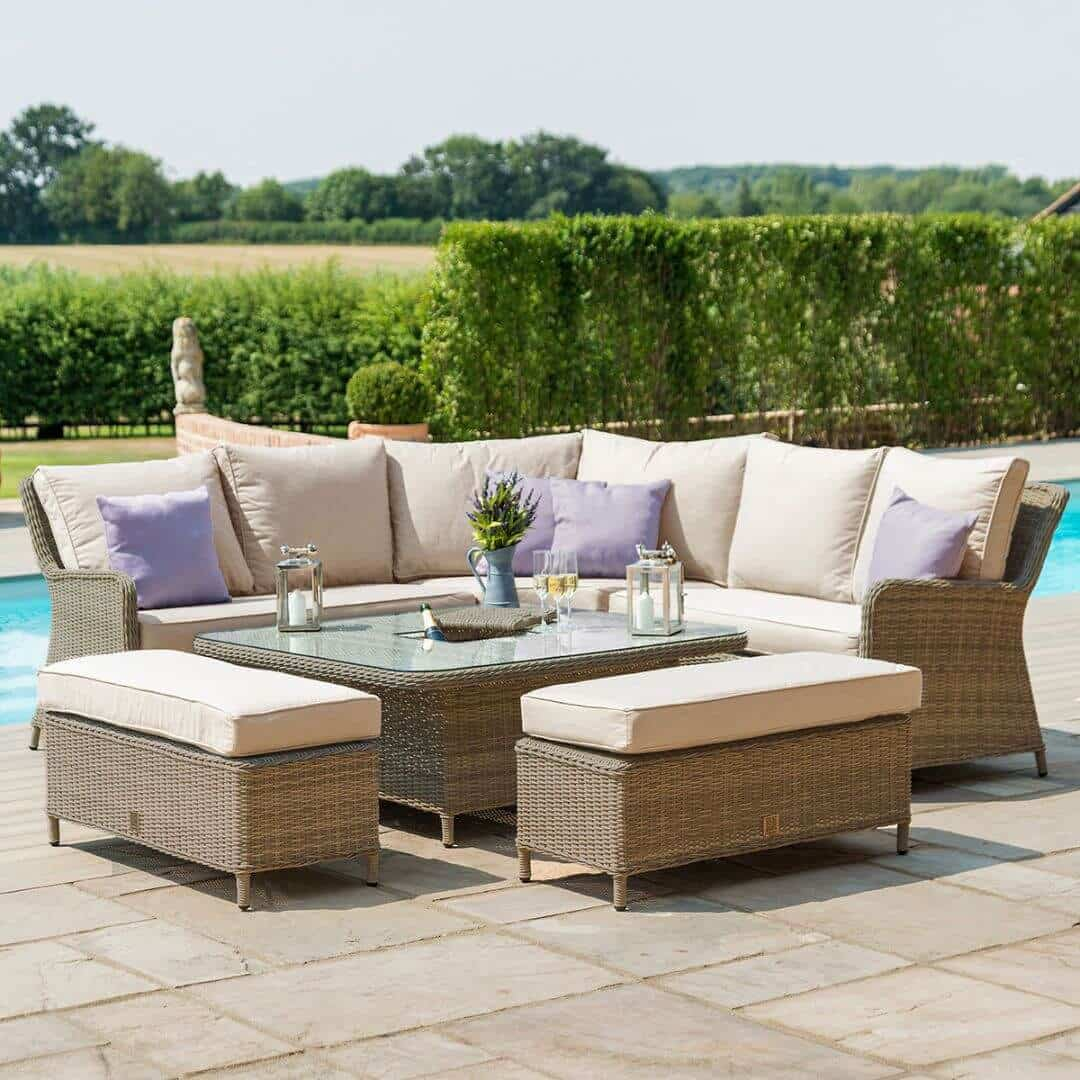 Natural coloured rattan corner sofa dining set with two benches and an ice bucket rising table. Table is low.