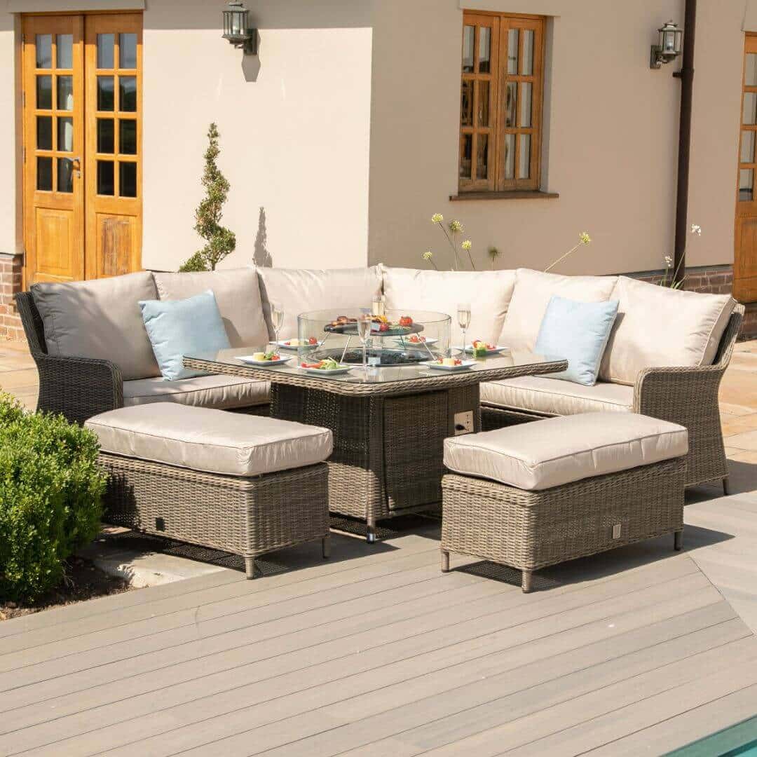 Natural coloured rattan corner sofa with two matching benches and square fire pit table.