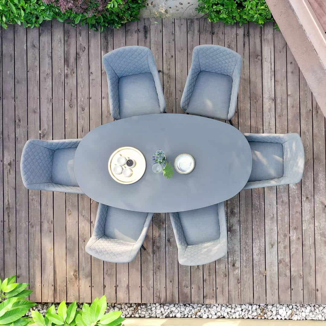 Overhead view of a 6 seat oval dining set with grey fabric dining chairs #colour_flanelle