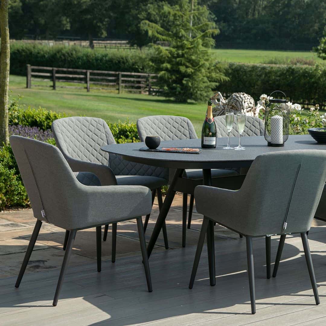 Close up of an 8 seat oval dining set with grey fabric dining chairs #colour_flanelle